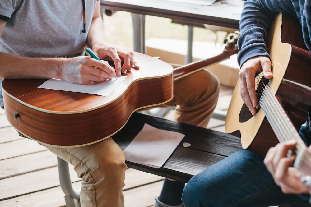 Two people play guitar