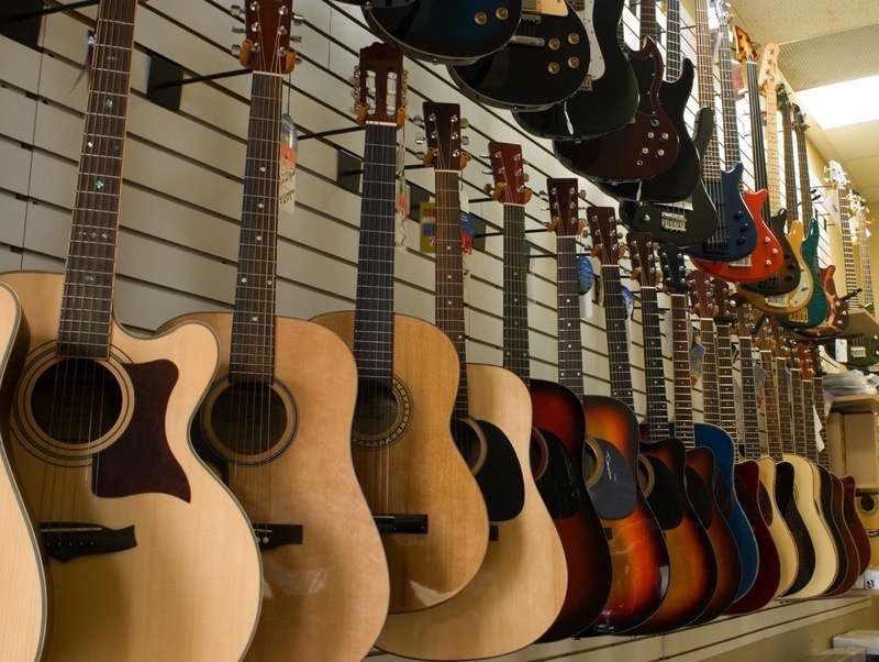 Wall of guitars at a repair shop